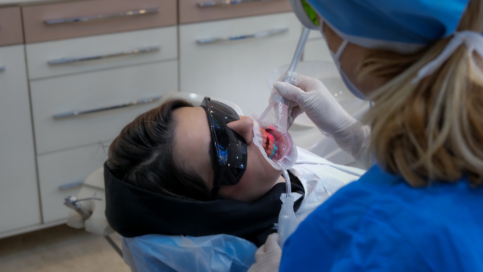 Patient receiving a detailed dental exam for cosmetic smile enhancement