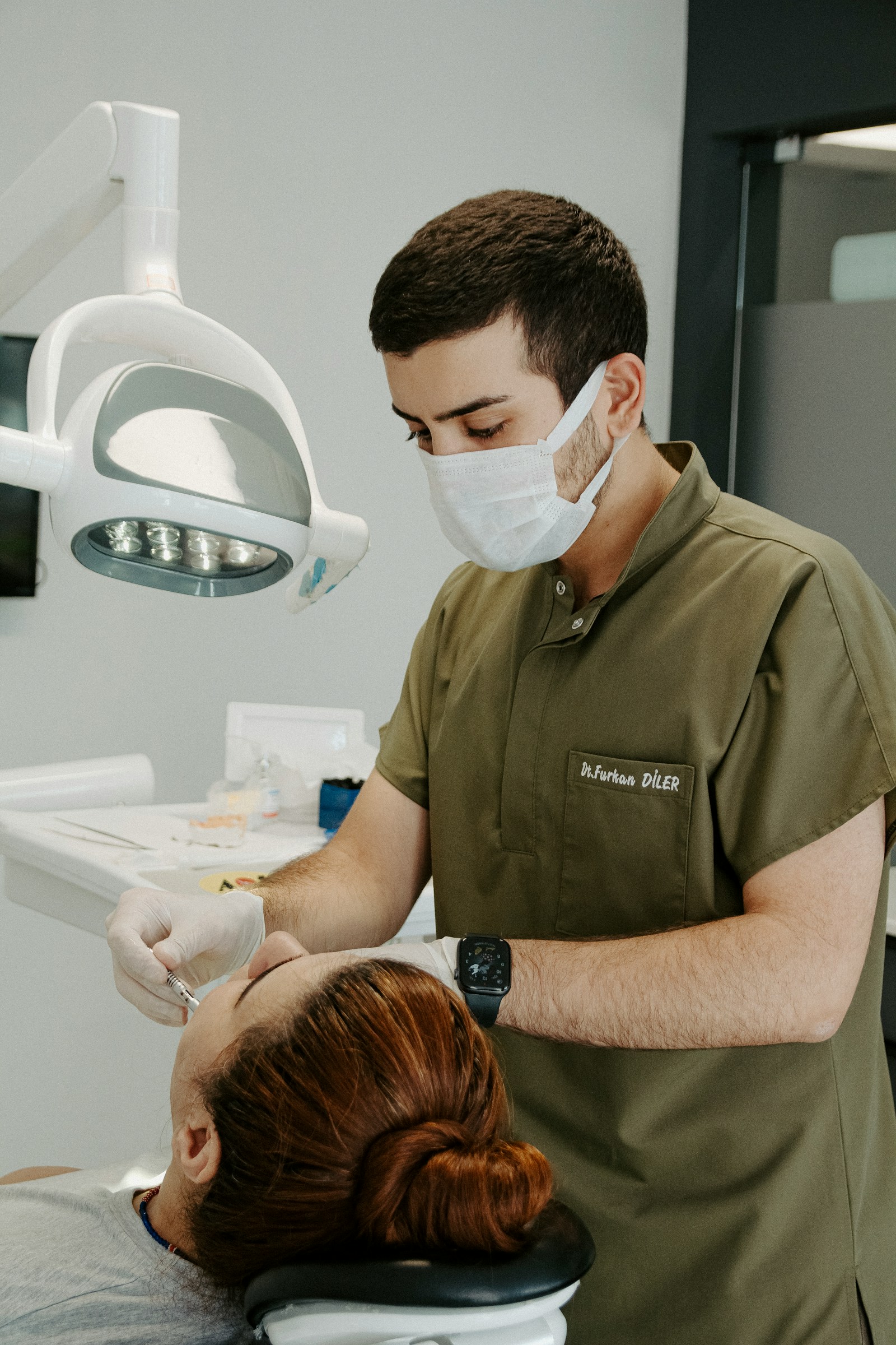 Dentist examining a patient's mouth during a preventive screening