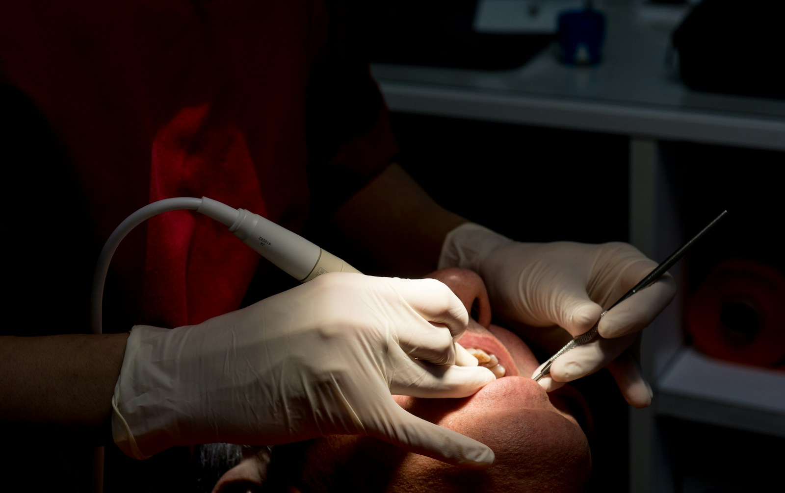 Dental hygienist cleaning a patient's teeth with professional tools